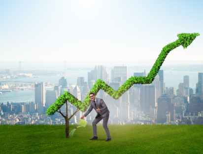 A businessman waters a small tree that grows into a large, green upward arrow, symbolizing sustainable growth, with a city skyline in the background. This image illustrates the role of marketing in promoting environmentally responsible business practices and consumer behaviors.
